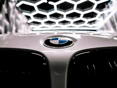 BMW roundel on a bonnet under hexagonal workshop lighting