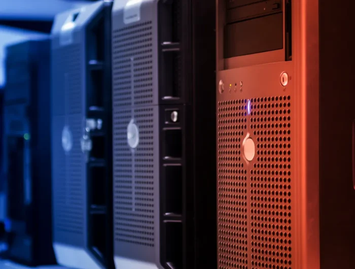 Close-up of tower servers in a data center with blue and red lighting